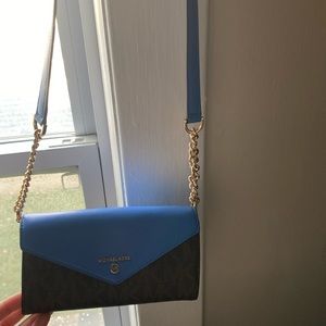 This is a Michael Kors cross bag small with a lot of pockets